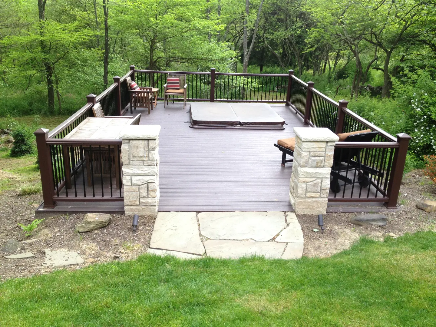 A deck with benches and a bench in the middle of it.