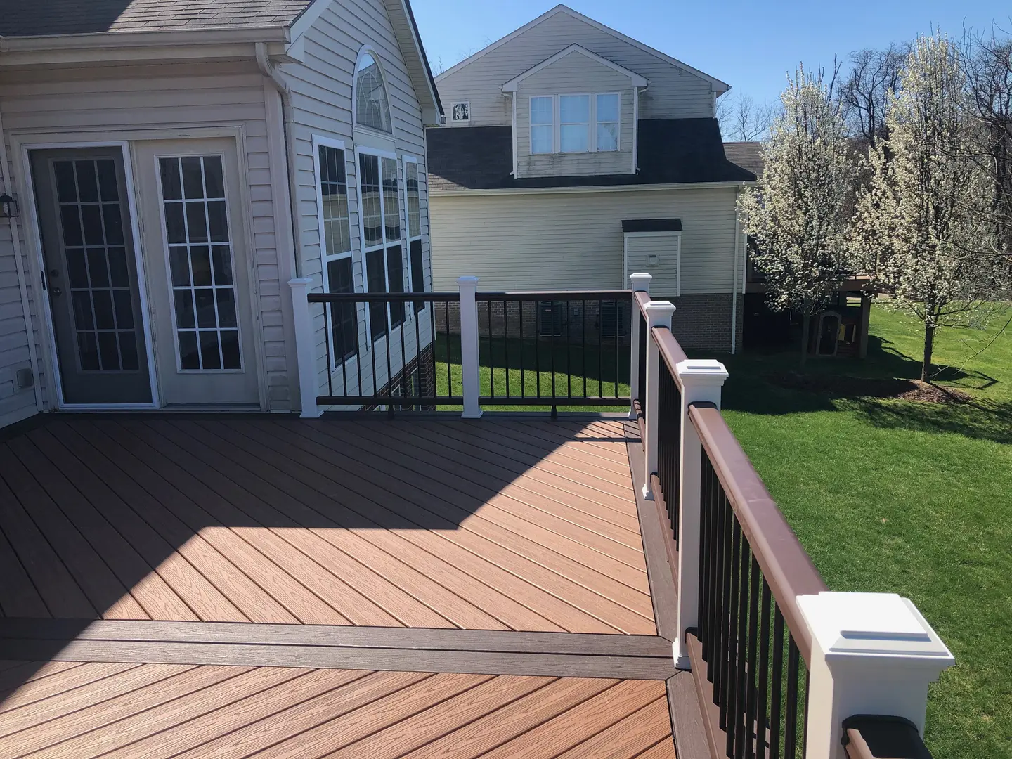 A deck with a railing and a fence