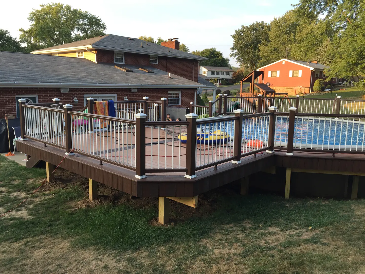 A deck with a pool in the middle of it