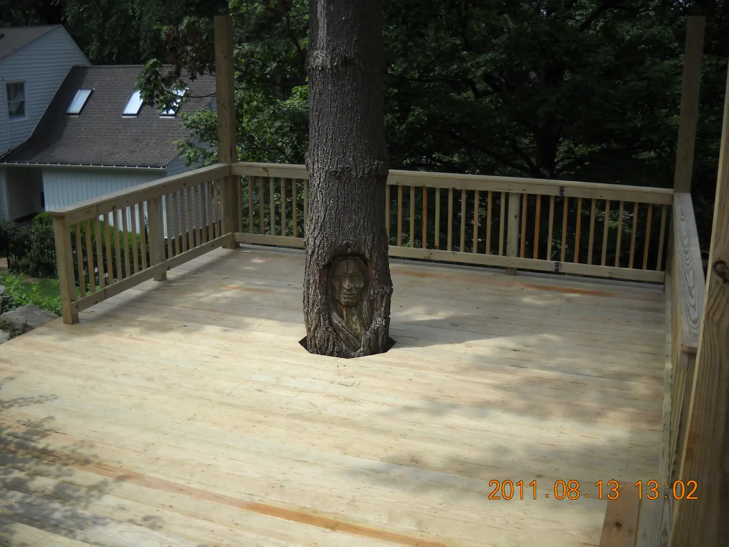 A tree that is sitting in the middle of a deck.