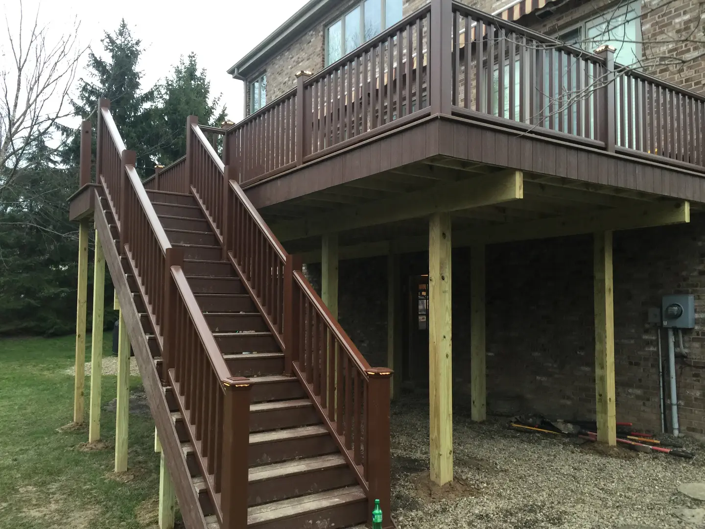 A wooden staircase leading to the top of a deck.