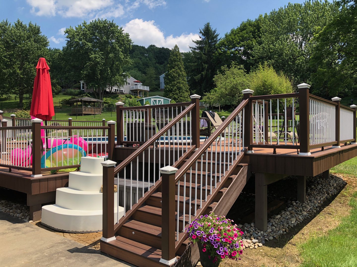 A deck with stairs and steps leading to the top.