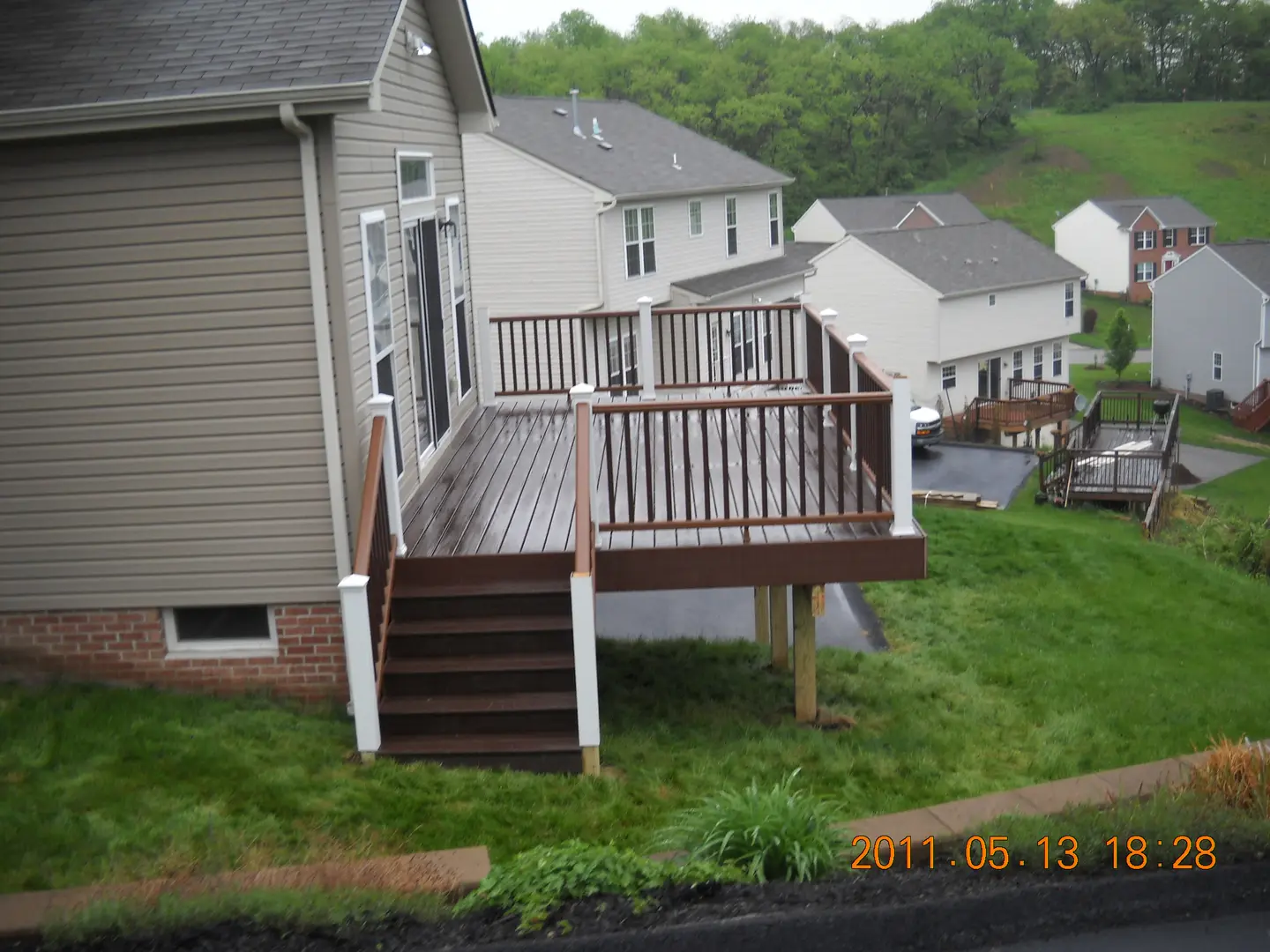 A house with a deck and steps in the middle of it