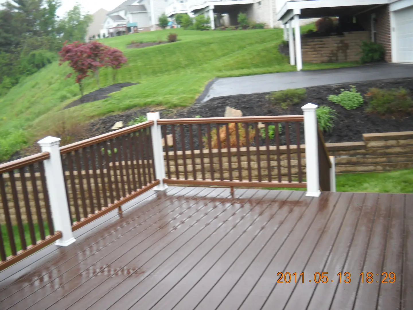 A deck with a fence and trees in the background