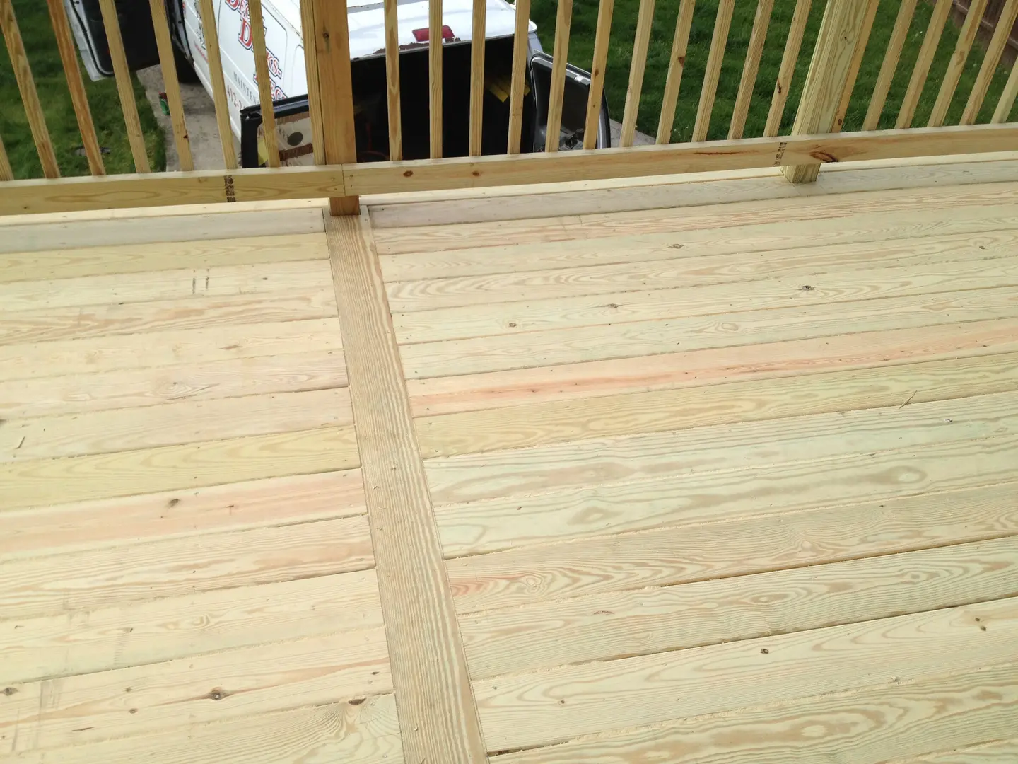 A wooden deck with no railing and no handrail.