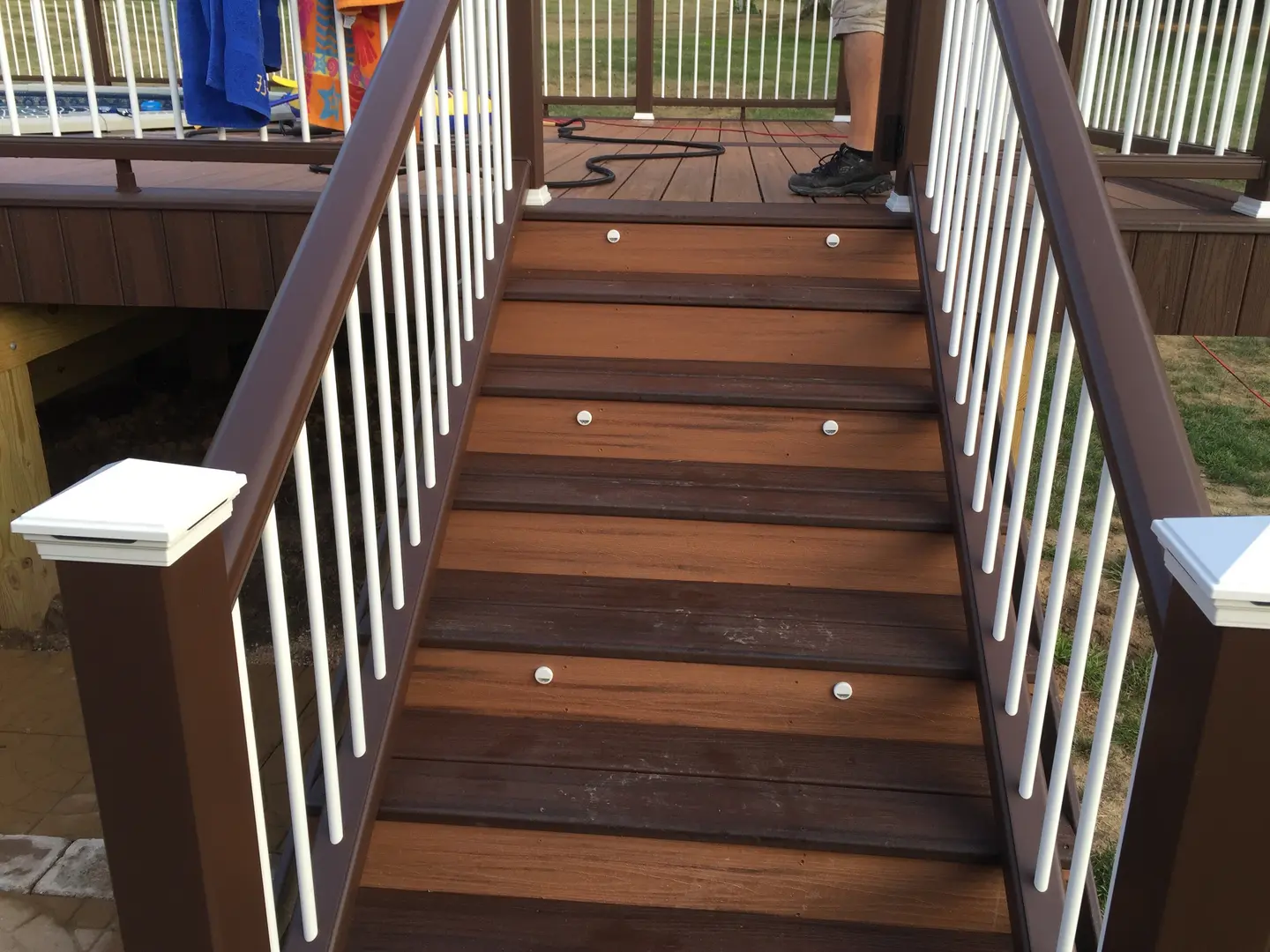 A wooden staircase with lights on the bottom of it.