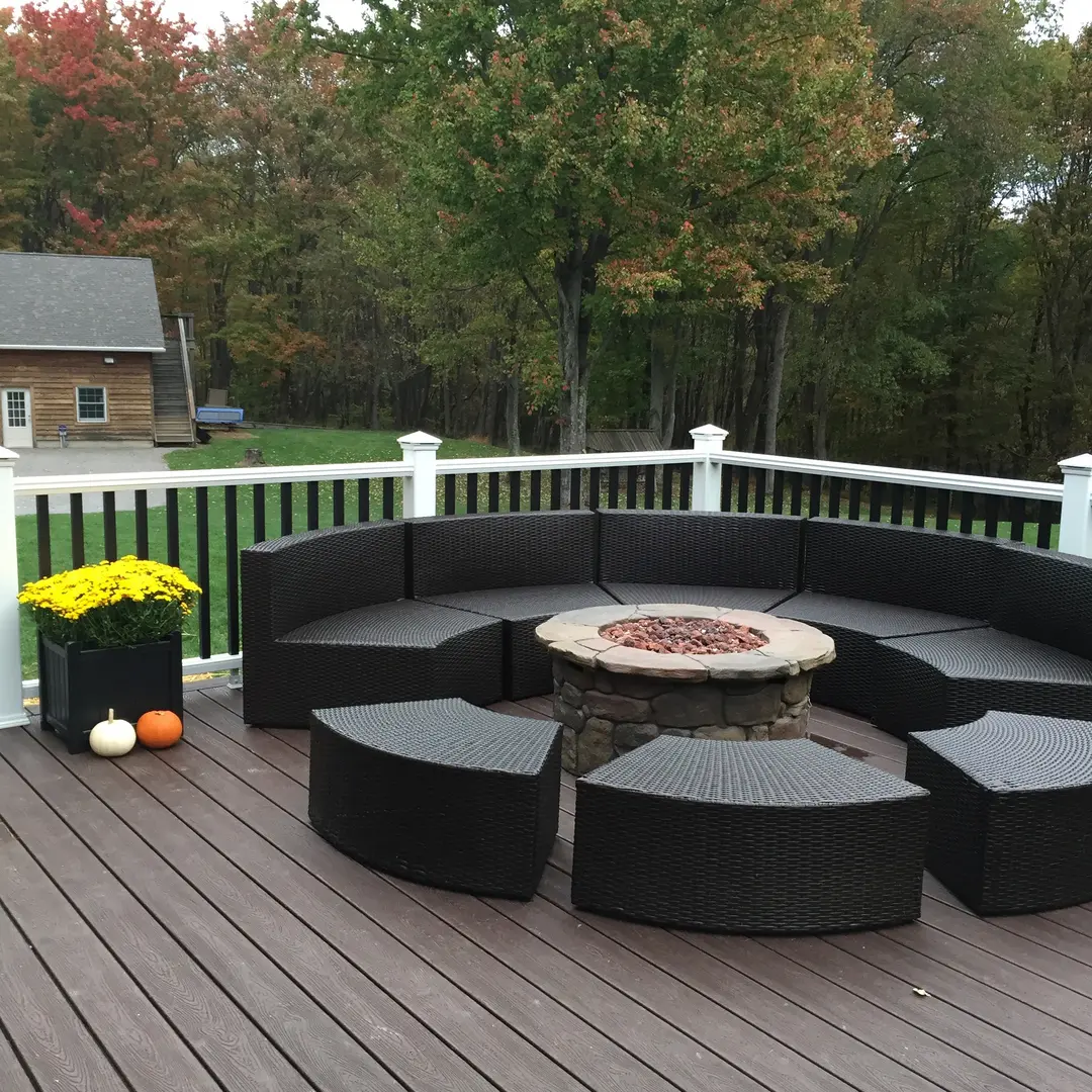 A fire pit sitting on top of a wooden deck.